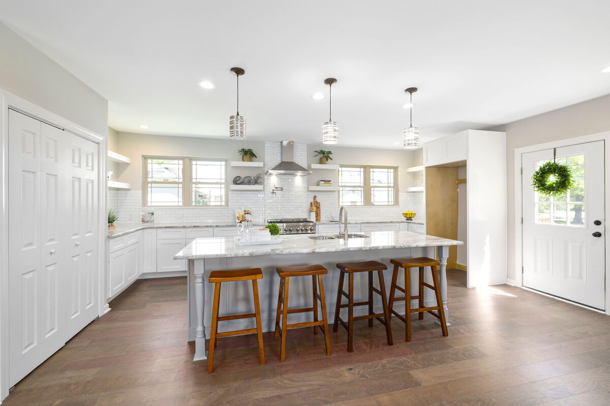 White kitchen with island and four stools